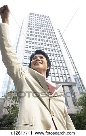 Stock Image - Businessman raising a hand. Fotosearch