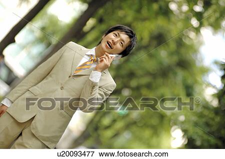 Businessman talking with a cell phone View Large Photo Image Stock Photo - Businessman talking with a cell phone. Fotosearch