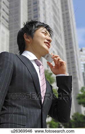 Businessman talking with a cell phone View Large Photo Image Stock Photograph - Businessman talking with a cell phone. Fotosearch