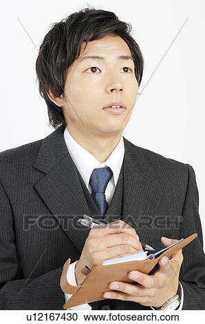 Businessman writing a schedule to the notebook View Large Photo Image Stock Image - Businessman writing a schedule to the notebook. Fotosearch