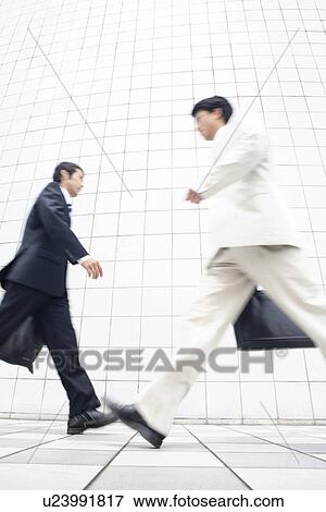 Stock Photo - Businessmen intersecting each other. Fotosearch