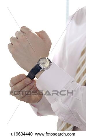 Office worker putting on a watch View Large Photo Image Stock Image - Office worker putting on a watch. Fotosearch