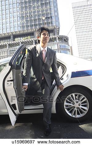Office worker who gets off the taxi View Large Photo Image Stock Photo - Office worker who gets off the taxi. Fotosearch