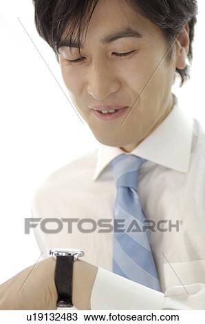 Stock Image - Office worker who sees a watch. Fotosearch