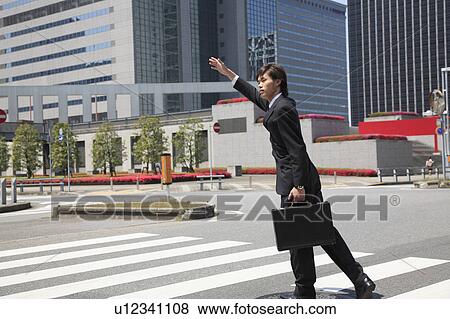 Stock Photo - Office worker who waits for the taxi. Fotosearch