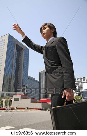 Office worker who waits for the taxi View Large Photo Image Stock Photograph - Office worker who waits for the taxi. Fotosearch