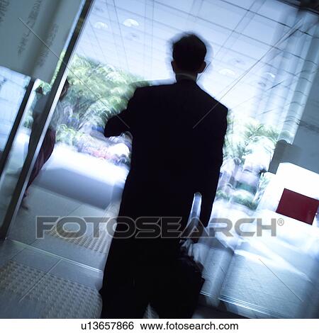 A businessman leaving building, blurred motion View Large Photo Image Stock Photograph - A businessman leaving building, blurred motion. Fotosearch