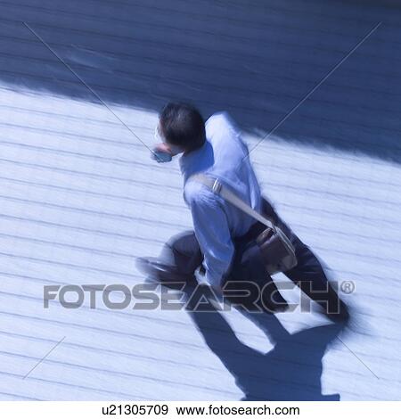 A businessman walking on street, blurred motion View Large Photo Image Stock Photo - A businessman walking on street, blurred motion. Fotosearch