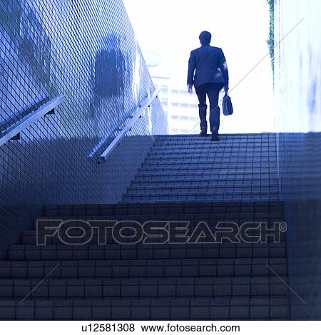 A businessman walking up steps View Large Photo Image Stock Photo - A businessman walking up steps. Fotosearch