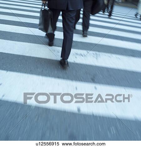 Stock Photography - Businessmen crossing zebra crossing. Fotosearch