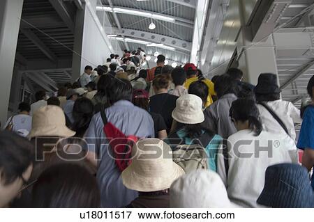 Stock Photo - Group of people climbing steps in station. Fotosearch