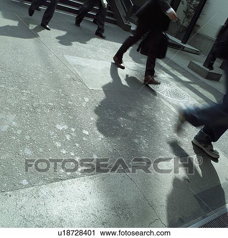 Stock Image - Low section of businessmen walking. Fotosearch