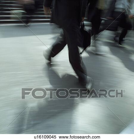 Low section of businessmen walking, blurred motion View Large Photo Image Stock Photography - Low section of businessmen walking, blurred motion. Fotosearch