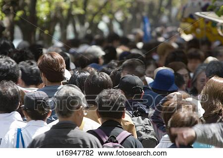 Stock Image - People coming to view cherry blossoms. Fotosearch