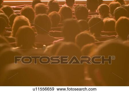 Stock Photo - People sitting in theater. Fotosearch