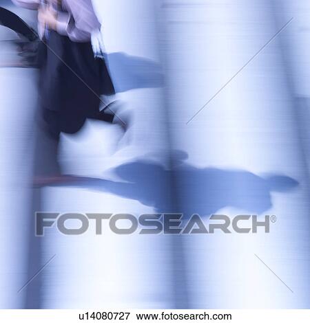 Shadows of businessmen walking, blurred motion View Large Photo Image Stock Photo - Shadows of businessmen walking, blurred motion. Fotosearch