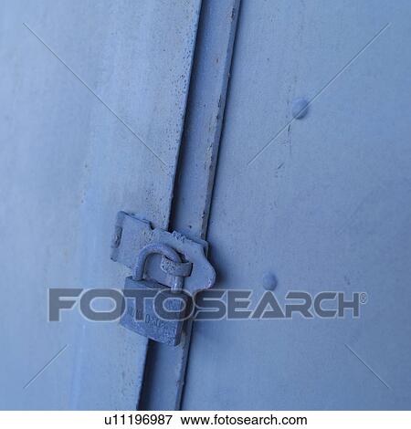 Stock Photo - Metal padlock attached to door. Fotosearch