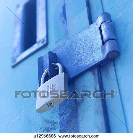 Stock Photograph - Metal padlock attached to door. Fotosearch