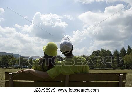 Husband and wife sitting on bench View Large Photo Image Stock Photo - Husband and wife sitting on bench. Fotosearch