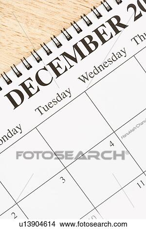 Close up of spiral bound calendar displaying month of December View Large Photo Image Picture - Close up of spiral bound calendar displaying month of December. Fotosearch