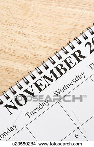 Close up of spiral bound calendar displaying month of November View Large Photo Image Picture - Close up of spiral bound calendar displaying month of November. Fotosearch