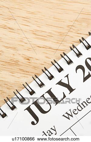 Close up of spiral bound calendar displaying month of July View Large Photo Image Stock Photograph - Close up of spiral bound calendar displaying month of July. Fotosearch