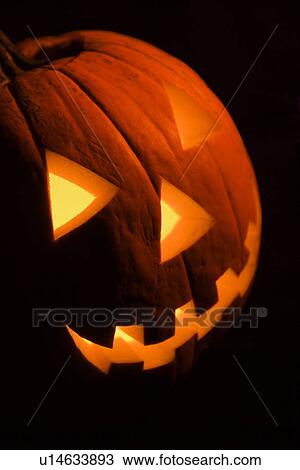 Carved Halloween pumpkin glowing in the dark. View Large Photo Image Stock Image - Carved Halloween pumpkin glowing in the dark.. Fotosearch
