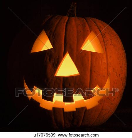 Carved Halloween pumpkin glowing in the dark. View Large Photo Image Stock Photo - Carved Halloween pumpkin glowing in the dark.. Fotosearch