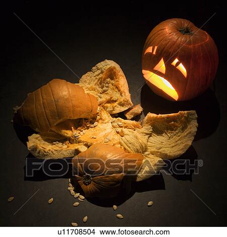 Upset jack-o'-lantern looking at smashed pumpkin. View Large Photo Image Picture - Upset jack-o'-lantern looking at smashed pumpkin.. Fotosearch