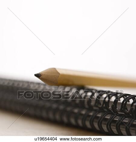 Close up of pencil on top of spiral bound notebook View Large Photo Image Picture - Close up of pencil on top of spiral bound notebook. Fotosearch