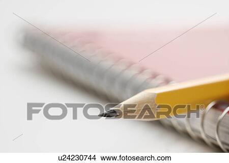 Close up of pencil on top of spiral bound notebook View Large Photo Image Picture - Close up of pencil on top of spiral bound notebook. Fotosearch