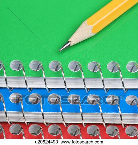 Close up of pencil on top of three spiral bound notebooks View Large Photo Image Stock Image - Close up of pencil on top of three spiral bound notebooks. Fotosearch
