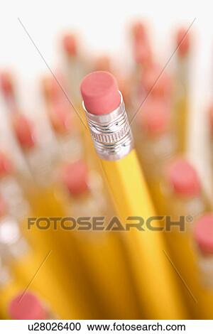 Stock Image - Group of eraser ends of pencils with one standing out higher than the rest. Fotosearch