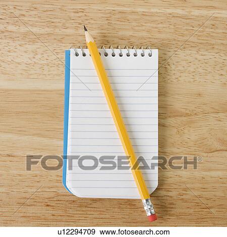 Pencil on top of open spiral bound notepad View Large Photo Image Stock Photo - Pencil on top of open spiral bound notepad. Fotosearch