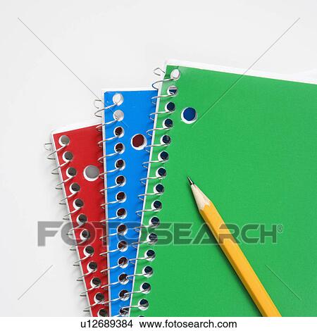Picture - Pencil on top of three spiral bound notebooks. Fotosearch