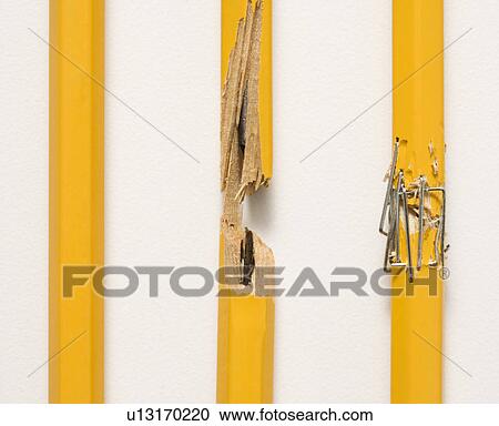 Stock Image - Whole pencil, broken pencil and stapled together pencil lined up against white background. Fotosearch