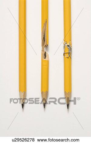 Stock Photo - Whole pencil, broken pencil and stapled together pencil lined up against white background. Fotosearch