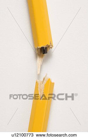Stock Image - Wooden yellow pencil broken with lead exposed against white background. Fotosearch