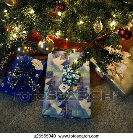 Stock Image - Christmas presents under decorated Christmas tree. Fotosearch