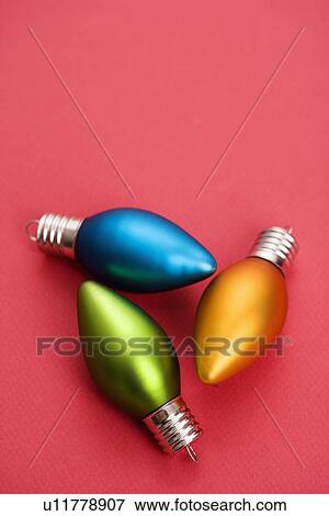 Still life of blue, green and orange Christmas ornaments on red background. View Large Photo Image Stock Photo - Still life of blue, green and orange Christmas ornaments on red background.. Fotosearch