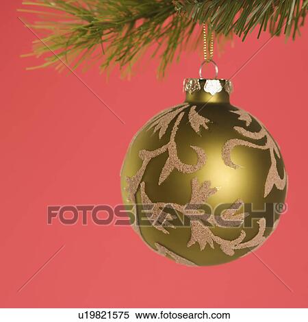 Still life of gold Christmas ornament hanging from pine branch. View Large Photo Image Stock Photography - Still life of gold Christmas ornament hanging from pine branch.. Fotosearch