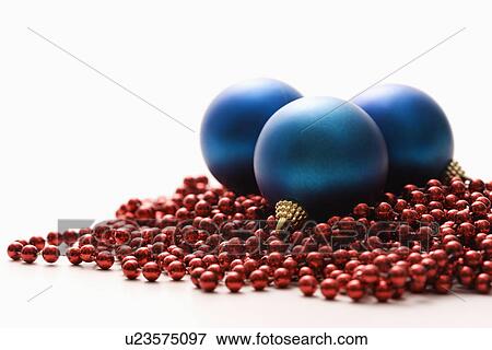 Still life of large blue Christmas ornaments and strings of red beads View Large Photo Image Stock Photo - Still life of large blue Christmas ornaments and strings of red beads. Fotosearch
