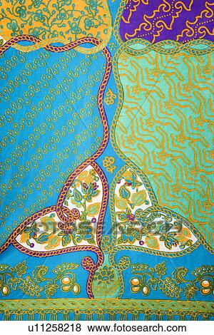 Stock Photo - Close-up of colorful vintage fabric with abstract blue and turquoise shapes printed on polyester. Fotosearch