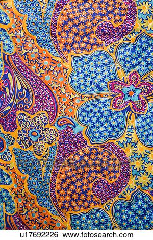 Stock Photograph - Close-up of colorful vintage fabric with flowers and shapes printed on polyester. Fotosearch