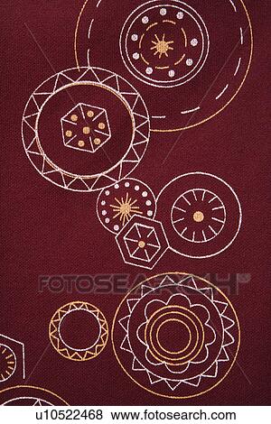 Stock Photo - Close-up of maroon vintage fabric with white and yellow lines and shapes printed on polyester. Fotosearch