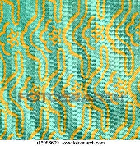 Stock Photo - Close-up of turquoise vintage fabric with repetitive yellow designs printed on polyester. Fotosearch
