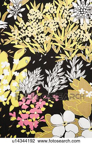 Stock Image - Close-up of vintage fabric with pattern of pink and golden flowers and leaves on polyester. Fotosearch