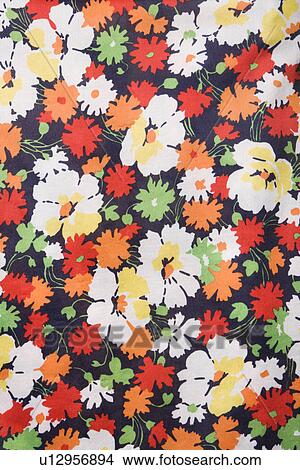 Picture - Close-up of vintage fabric with colorful flowers printed on polyester. Fotosearch