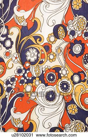Stock Image - Close-up of vintage fabric with red blue and gold flowers and swirls printed on polyester. Fotosearch