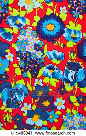 Stock Image - Close-up of vintage fabric with vibrant blue and turquoise flowers printed on polyester. Fotosearch